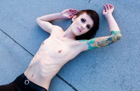 Skinny alt babe with tattooed body exposing tiny tits outdoors on rooftop