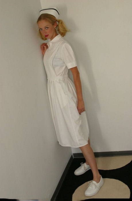 Amateur model frees her firm tits and twat from vintage nursing attire