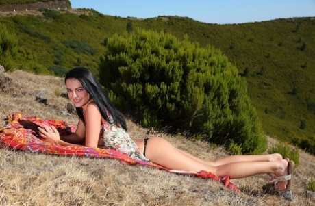 Dark haired teen Sapphira frees her tight ass and twat from thong panties