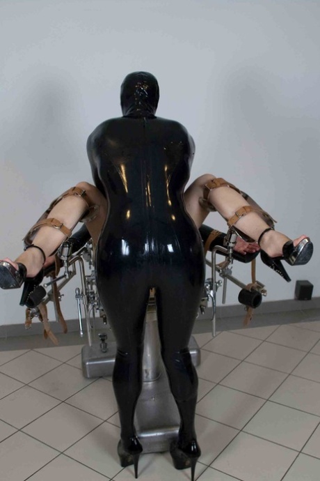 Bottomless female sex slave is machine fucked while strapped to gyno chair