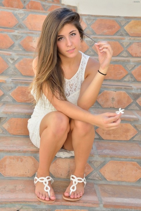 Young brunette cutie inserting massive dildo into tight vagina outdoors