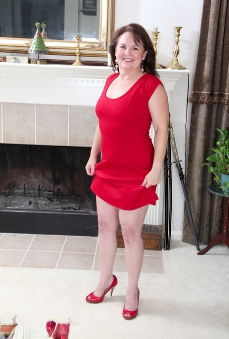 Older amateur Felicia Mcdonald doffs a red dress before parting her pussy lips