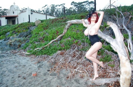 Leggy redhead pornstar Tessa Fowler touting huge natural tits outdoors
