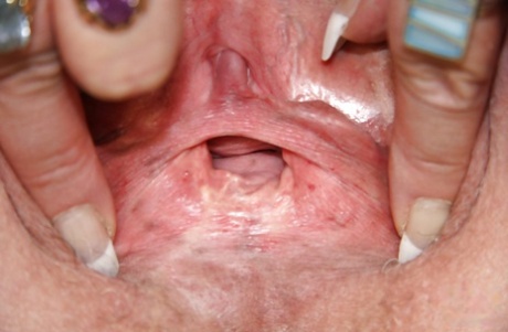 Horny granny playing with her huge flabby tits and toying her shaved cunt