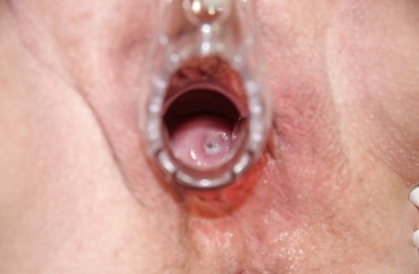 Horny granny playing with her huge flabby tits and toying her shaved cunt
