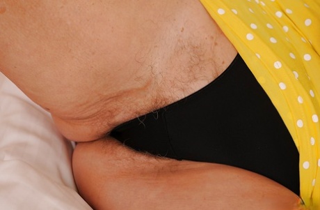 Smiley blonde granny getting naked and exposing her hairy cunt