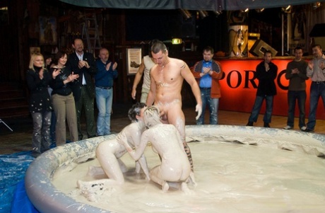 Lesbian MILFs with big breasts having a wild FFM threesome in a mud pool