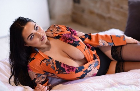 Brunette fatty Foxy Lucina unveils her incredibly big natural tits on her bed