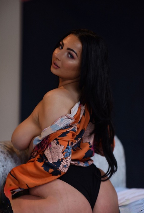 Brunette fatty Foxy Lucina unveils her incredibly big natural tits on her bed