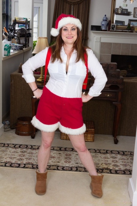 Annatasia Holland strips her Xmas outfit & shows her huge tits & hairy crotch