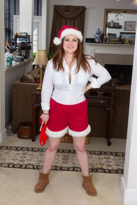 Annatasia Holland strips her Xmas outfit & shows her huge tits & hairy crotch