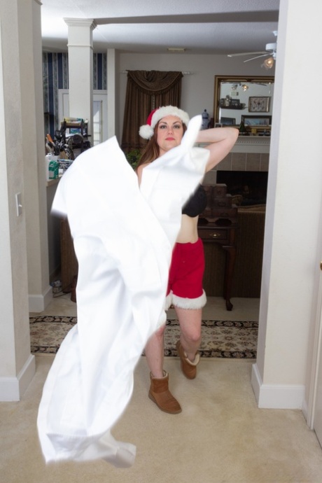Annatasia Holland strips her Xmas outfit & shows her huge tits & hairy crotch