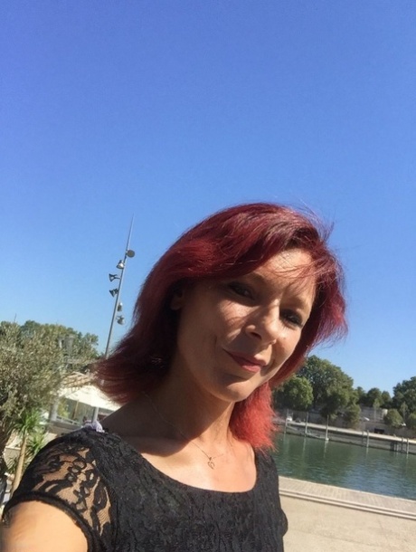 Sexy French redhead mature Morgane Dell flashes her cunt in public