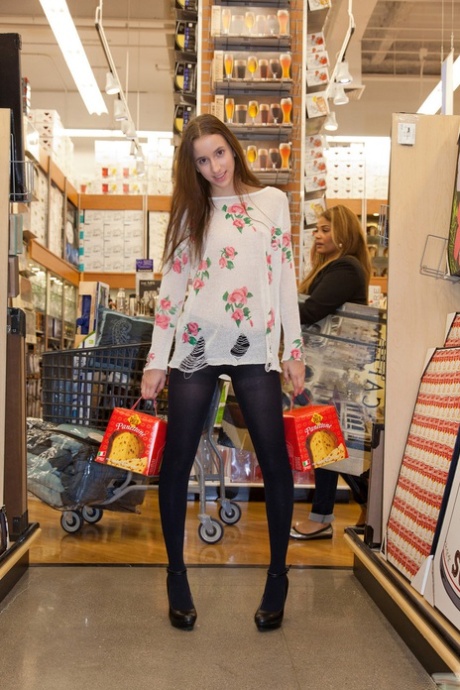 Naughty skinny chick Belle Knox flashes tits and ass in the local store