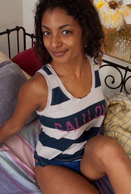 Exotic dark skinned Neela Sky reveals her hairy ebony pussy & toys on the bed