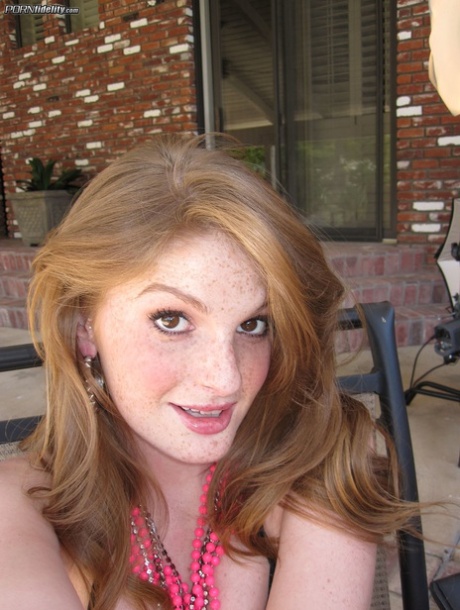 Freckled ginger Faye Reagan gets undressed to show her nice medium tits