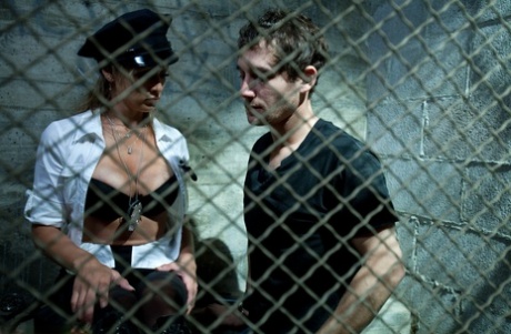 Officer Felony bends over the inmate and gives him a prostate exam