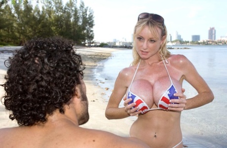 Mature Morgan Leigh doffs patriotic bikini for big boob beach titty fuck
