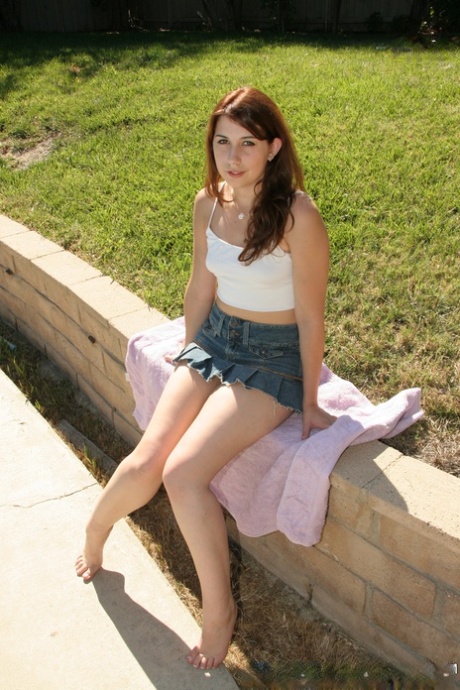 18+ teen Victoria Raven takes off her clothes by a backyard pool