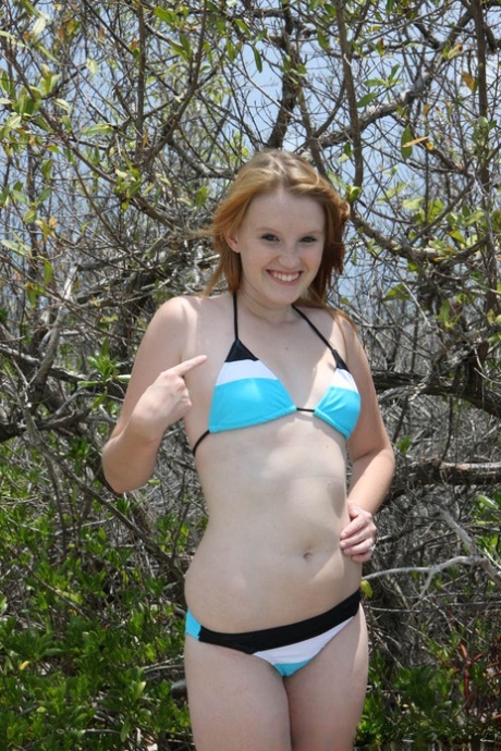 18 year old redhead babe Katey Grind stripping on the nudist beach