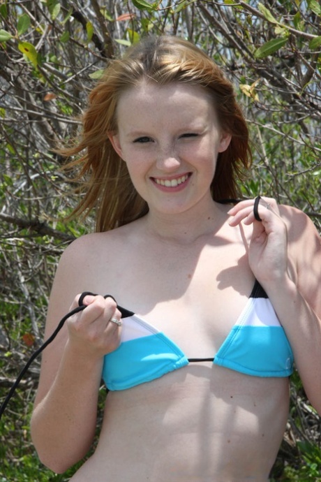18 year old redhead babe Katey Grind stripping on the nudist beach