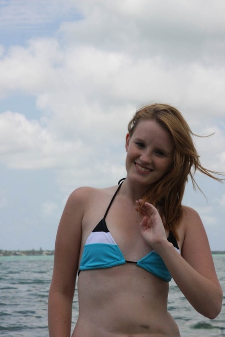 18 year old redhead babe Katey Grind stripping on the nudist beach