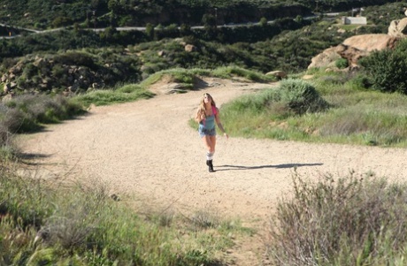 Sexy blonde Bailey Blue spreads her pussy while posing bound on a huge rock