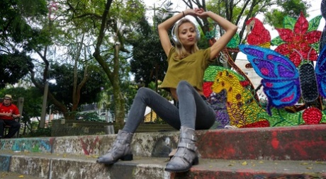 Veronica Leal posing all over her hood in green shirt and tight jeans
