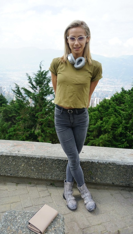 Veronica Leal posing all over her hood in green shirt and tight jeans