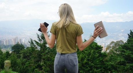 Veronica Leal posing all over her hood in green shirt and tight jeans