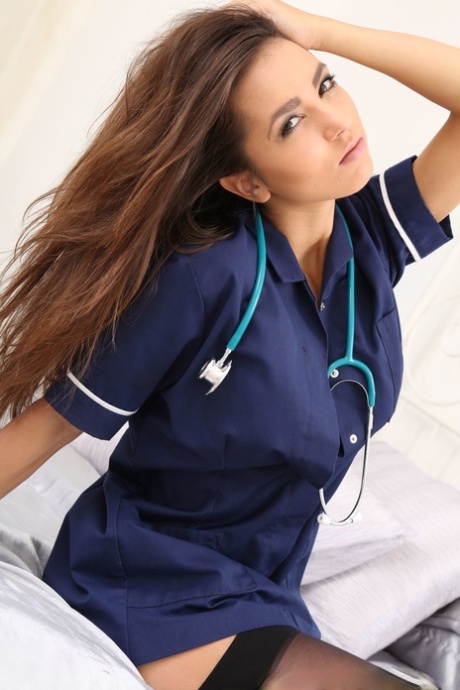Cute petite nurse Kitti strips her uniform & teases with body in sexy lingerie