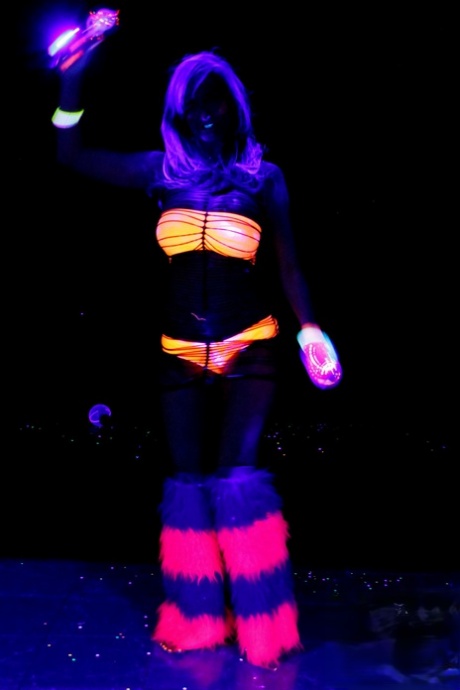 Huge boobed French MILF posing in her slutwear under the flashing lights