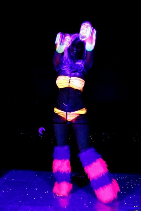 Huge boobed French MILF posing in her slutwear under the flashing lights