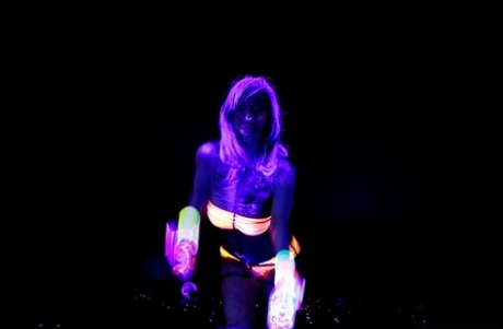 Huge boobed French MILF posing in her slutwear under the flashing lights
