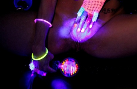 Huge boobed French MILF posing in her slutwear under the flashing lights