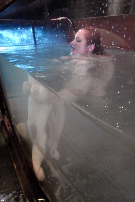 Redheaded MILF with big tits Mz Berlin gets toyed under water while tied up