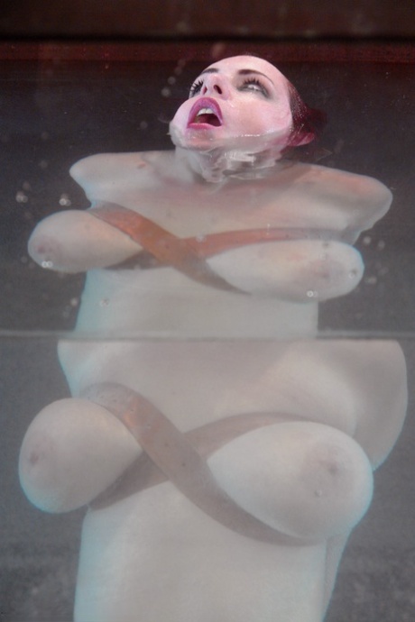 Redheaded MILF with big tits Mz Berlin gets toyed under water while tied up