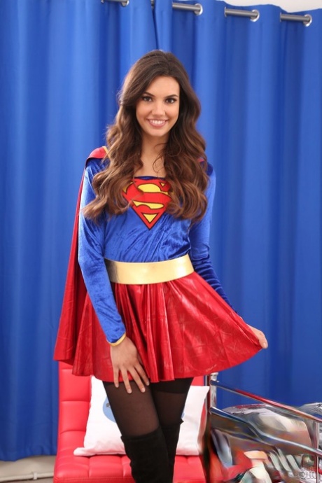Alluring doll Abigail B poses in supergirl costume and teases with her tits