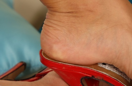 Leggy babe Zara A teases with her feet in various pairs of high heel sandals