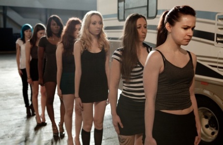 Lined up damsels in handcuffs getting stripped by their male BDSM handlers