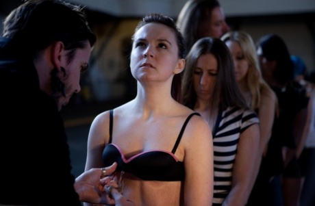 Lined up damsels in handcuffs getting stripped by their male BDSM handlers