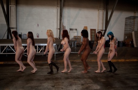 Lined up damsels in handcuffs getting stripped by their male BDSM handlers