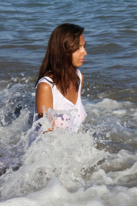 Exotic naturally busty teen model Madlen strips naked & poses in the sea