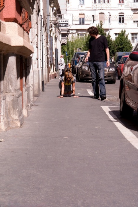 Romanian beauty Jennifer Love crawling on the street ball-gagged and shackled