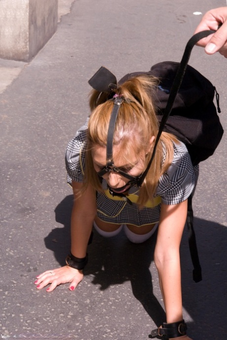 Romanian beauty Jennifer Love crawling on the street ball-gagged and shackled