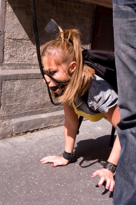 Romanian beauty Jennifer Love crawling on the street ball-gagged and shackled