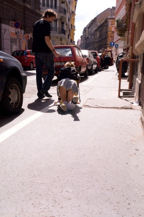 Romanian beauty Jennifer Love crawling on the street ball-gagged and shackled