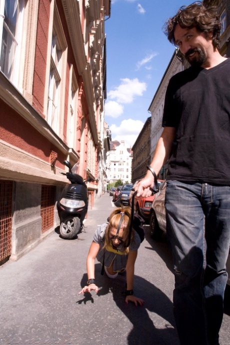 Romanian beauty Jennifer Love crawling on the street ball-gagged and shackled