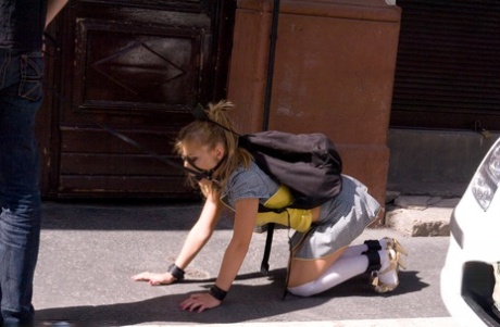 Romanian beauty Jennifer Love crawling on the street ball-gagged and shackled