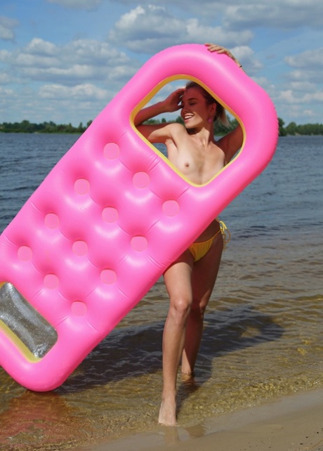 Ukrainian beauty Lola Krit strips on a floaty and displays her tits and holes